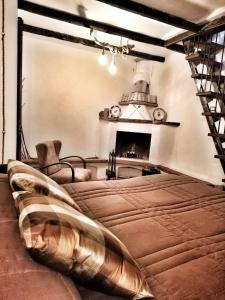 a bedroom with a bed and a fireplace at Casa borghetto in Cancellara