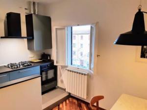 a small kitchen with a stove and a window at Your apartment in the Heart of Florence in Florence