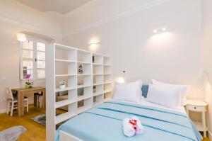 a bedroom with a blue bed with white shelves at Leonarda Baroque House - Old Town in Dubrovnik