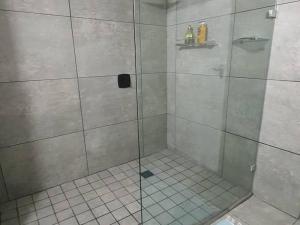 a shower with a glass door in a bathroom at Santos Beach Pavilion E in Mossel Bay