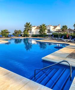 a swimming pool with blue water in a resort at Apartment in La Mairena in Mijas Costa