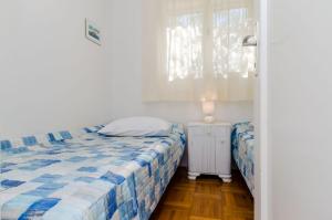a bedroom with two beds and a window at Apartment Neven in Trogir