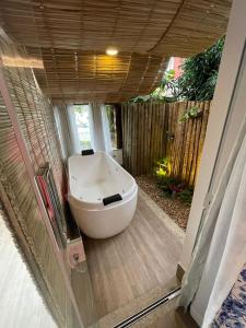 a bath tub sitting inside of a bathroom at Hotel Boutique Recanto da Passagem in Cabo Frio