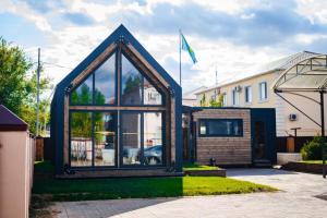 a small house with glass windows in a yard at Comfort Hotel in Aksay