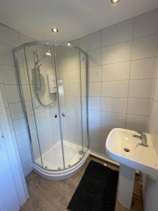 a bathroom with a shower and a sink at Chalet 208 In Glan Gwna Caernarfon in Caernarfon