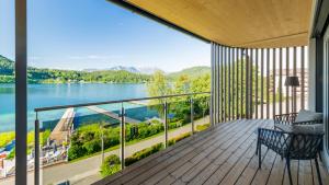 a balcony with a view of a lake and mountains at Seewirt Apartments in Klopein am Klopeiner See