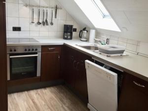 a kitchen with a sink and a dishwasher at Ferienwohnung Wiesinger in Windelsbach