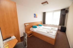 Postel nebo postele na pokoji v ubytování Hotel Rakovec