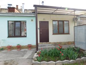 a house with a door and flowers in a yard at Апартамент в курзоне пр Кирова 7 in Pyatigorsk