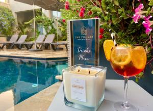 a candle and a glass of wine next to a pool at The Village Boutique and SPA in Naxxar