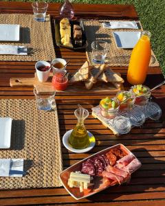 a picnic table with a plate of food and juice at No-Mad Green Hotel in Molinaseca