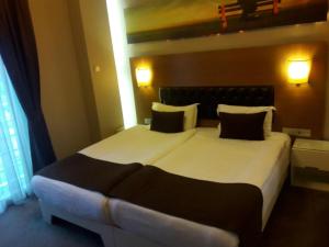 A bed or beds in a room at City Hotel Plovdiv