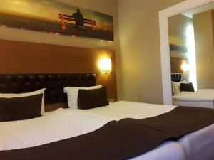 A bed or beds in a room at City Hotel Plovdiv