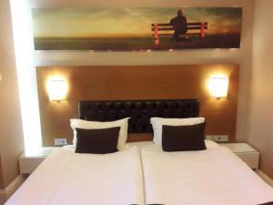 A bed or beds in a room at City Hotel Plovdiv