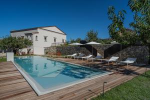 a swimming pool in front of a house at Laqua Countryside in Vico Equense