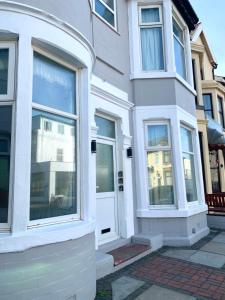 a white house with a white door and windows at Blackpool Lodge Apartments in Blackpool