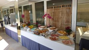 a buffet line with many different types of food at Hotel La Perla Del Capo in Ospedaletti