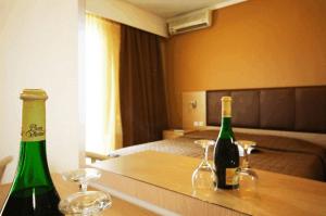 two bottles of wine on a table in a hotel room at Orpheus Hotel in Komotini