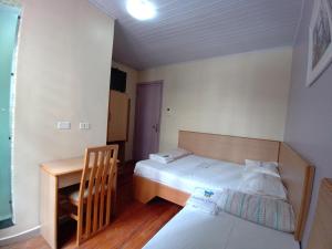 mały pokój z łóżkiem i stołem w obiekcie Hotel Pousada Viana w São Paulo