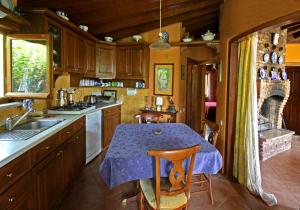 a kitchen with a table with a purple table cloth at Perfect Home with Private Beach by Iznik Lake in Bursa