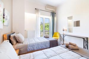 a bedroom with two beds and a window at Katsanis luxury apt., stunning view of acropolis in Athens