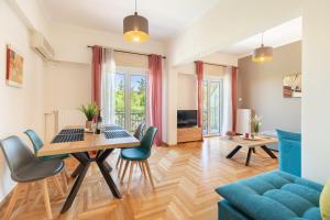 a living room with a table and a blue couch at Katsanis luxury apt., stunning view of acropolis in Athens