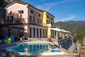 a house with a swimming pool in front of a building at Villa Lice Verici in Casarza Ligure