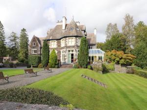 a large house with a lawn in front of it at Rydal Suite in Ambleside