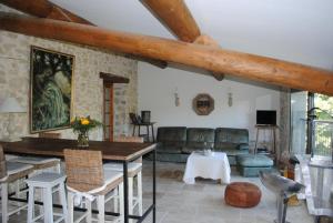 a living room with a couch and a table at le relais d'elle in Niozelles