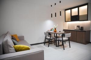 Il comprend une cuisine et un salon avec une table et des chaises. dans l'établissement BUKA Apart-Hotel & SPA, à Bukovel