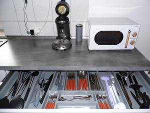 a drawer in a kitchen with a microwave and tools at Ipf Blick DG in Bopfingen