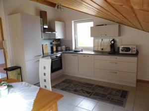 a small kitchen with white cabinets and a window at Ipf Blick DG in Bopfingen
