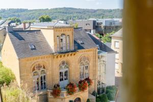 a large building with flower boxes on the windows at Hotel-Restaurant Moris in Walferdange