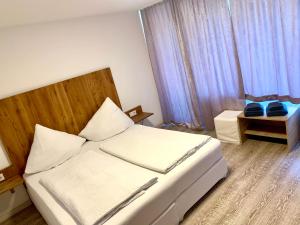 Postel nebo postele na pokoji v ubytování Smart Stay Rooms Feldkirch
