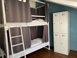 a bedroom with a bed and a desk at Safestay Bratislava in Bratislava