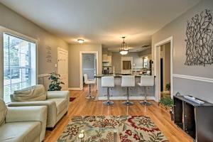 a living room with a couch and a kitchen at Modern Houston Home Less Than 4 Miles to Houston Zoo! in Houston