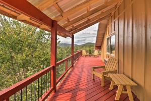 a porch of a cabin with a bench and chairs at Updated Mtn View Studio with Loft - Near River! in Mountain View
