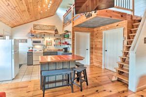 a kitchen with wooden floors and a staircase in a tiny house at Mountain View Escape - 1 Mile to White River! in Mountain View