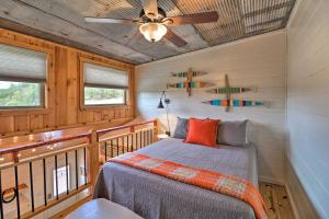 a bedroom with a bed and a ceiling fan at Mountain View Escape - 1 Mile to White River! in Mountain View
