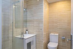 a bathroom with a toilet and a shower and a sink at Marina view sunny apartment in Fuengirola +6 photos