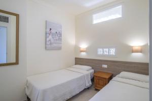 a room with two beds and a window at Marina view sunny apartment in Fuengirola