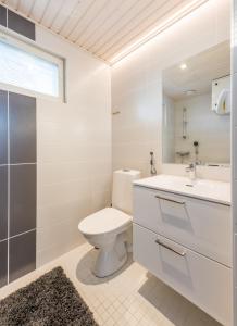 a bathroom with a toilet and a sink and a mirror at Rokovan Helmi - Natural peace in Ruka-Kuusamo in Ruka