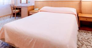 A bed or beds in a room at Hotel Terrazzo d'Abruzzo