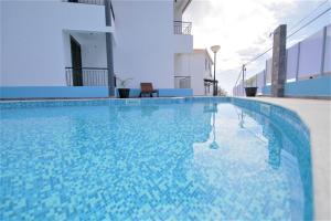 a swimming pool in the middle of a building at Vila Camacho Guest House in Funchal