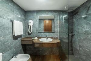 a bathroom with a sink and a shower at Essence Hotel Boutique in Torremolinos