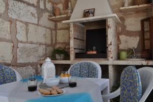 a table with blue chairs and a table with food on it at Casa Amanada in Santa Margalida