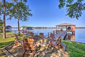 a dock with chairs and a gazebo on the water at Malakoff Home with Deck and Fire Pit Cedar Creek Lake in Malakoff