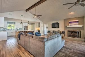 a living room with a couch and a kitchen at Malakoff Home with Deck and Fire Pit Cedar Creek Lake in Malakoff