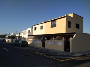a building on the side of a street at adosado cerca del mar in Playa Honda