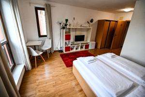 a bedroom with a bed and a living room at Aparthotel Faust in Děčín